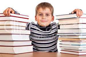 Schoolboy and a heap of books isolated on a white background