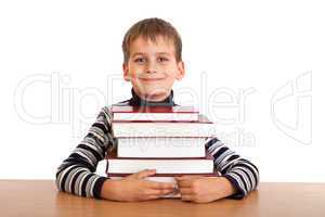 Schoolboy and a heap of books isolated on a white background