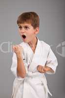 Karate boy in white kimono fighting
