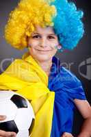 Football fan with  ukrainian flag on a black background