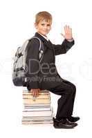 Schoolboy sitting on books. Back to school