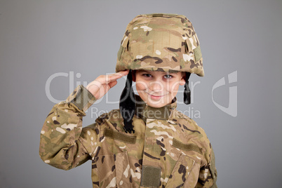 Saluting soldier. Young boy dressed like a soldier