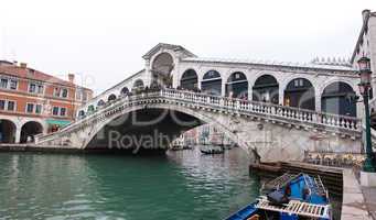 Venice Grand canal with gondolas and Rialto Bridge