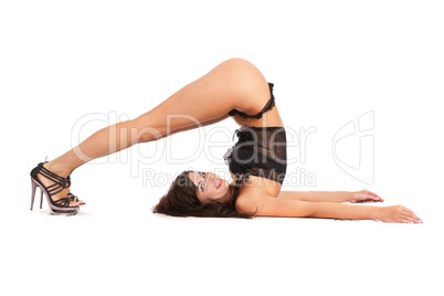 Sexy woman practicing yoga. Wears beautiful shoes