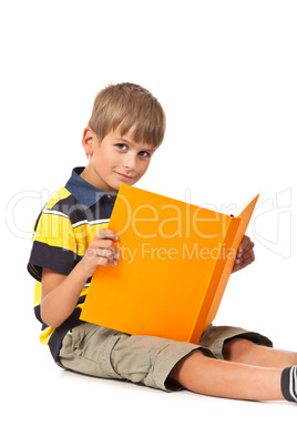 Schoolboy is holding a book on white