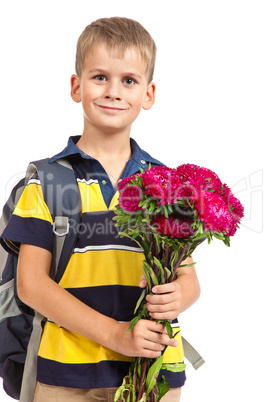 Schoolboy is holding flowers. Back to school