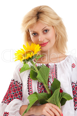 Woman wears Ukrainian dress is holding a sunflower