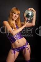 Beautiful young blonde holding a big disco ball