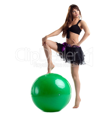 woman in dance costume posing with green ball