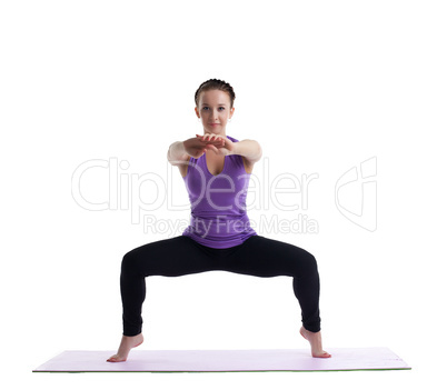 young brunette woman posing in yoga on rubber mat