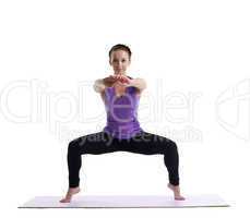 young brunette woman posing in yoga on rubber mat