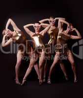 Group of women posing in gold costume