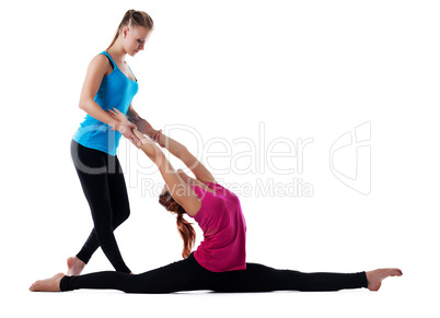 Fitness instructor help woman doing yoga asana