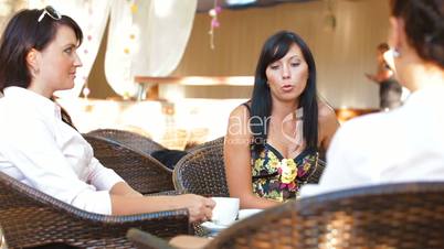 Female Lively Conversation at Outdoor Cafe