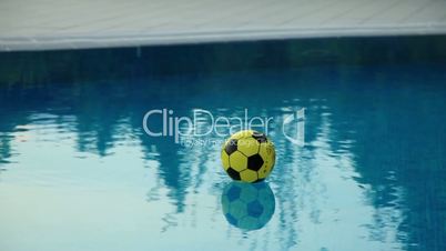 water reflection and soccer ball