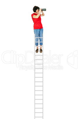 Woman standing on the ladder and looking into the distance with binoculars