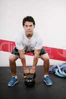 Young man Lifting Crossfit Kettle Bell