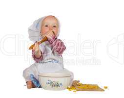 Small baby baker tasting the baking