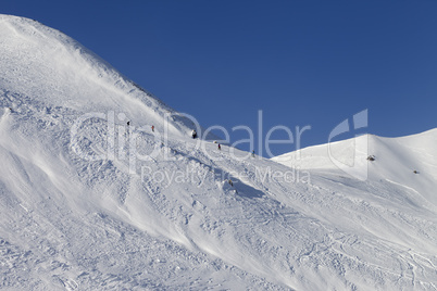 Skiers and snowboarders on ski piste