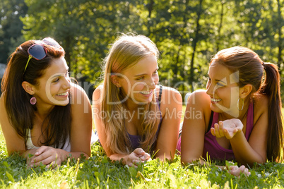 Teen women talking and relaxing in park