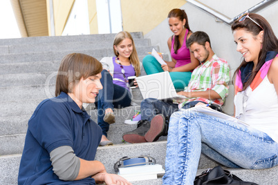 Students relaxing on high-school steps in break