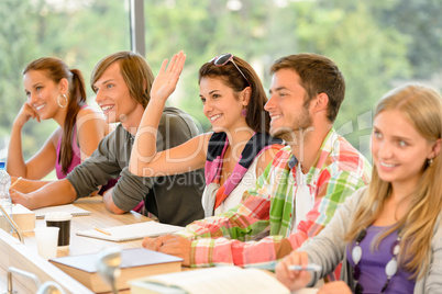 High-school student raising her hand in class