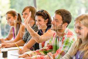 High-school student raising her hand in class