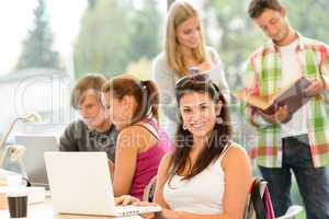 Teens studying in high-school library young pupils