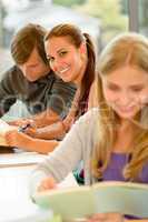 Teens study in high-school library reading student