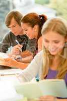 Teens study in high-school library reading student