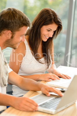 High-school students working on laptops in study