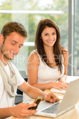 High-school students working on laptops in study