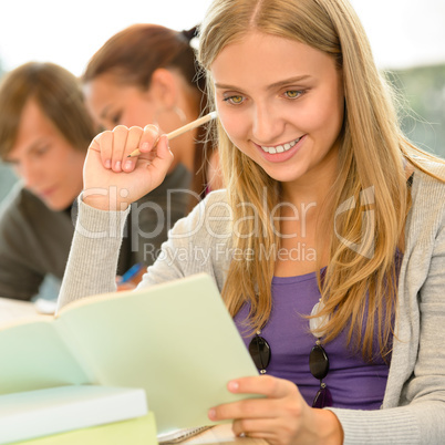 High-school student taking notes in library study