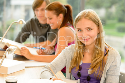 High-school student taking notes in study room