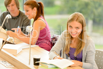 Student taking notes in study room