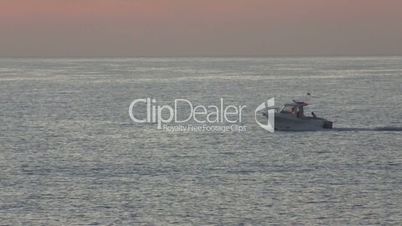 Motor boat sailing on the sea at dawn