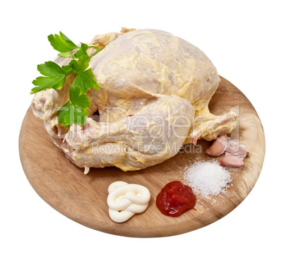 Raw chicken in the marinade on a white background