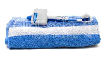 dental floss and toothbrush, towel on a white background