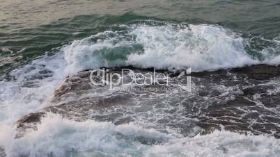 Waves breaking on the rocks, closeup