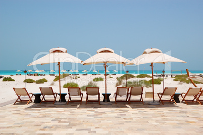 Sunbeds and umbrellas at the Beach of luxury hotel, Abu Dhabi, U