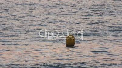 Yellow Buoy bobs on the waves, closeup