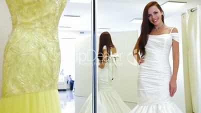 Bride Trying on Wedding Gown in Bridal Shop