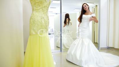 Bride Choosing Wedding Dress in Bridal Shop