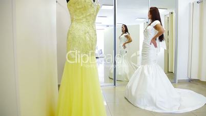Elegant Bride Trying On Wedding Dress in Bridal Boutique