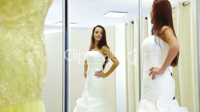 Bride Trying On Wedding Dress in Bridal Boutique