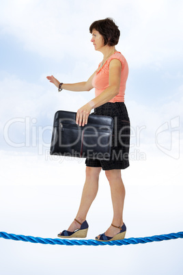 Business woman on tightrope