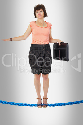 Business woman on tightrope