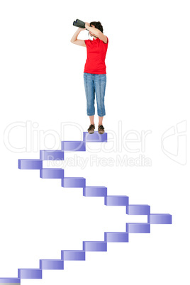 Woman standing on stairs and looking through the binoculars