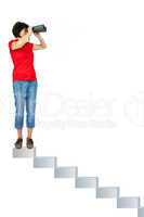 Woman standing on stairs and looking through the binoculars