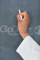 Close up of a teacher holding a white chalk